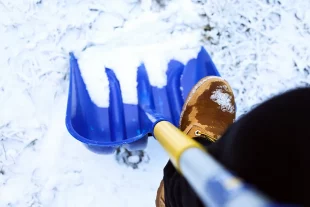 man-worker-uniform-shoveling-snow-close-up-image